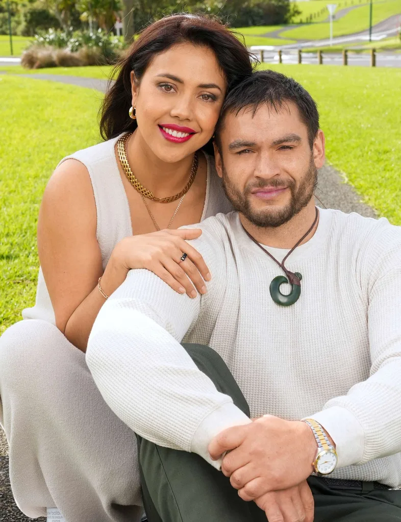 Ngahuia and Teone sitting in a park together