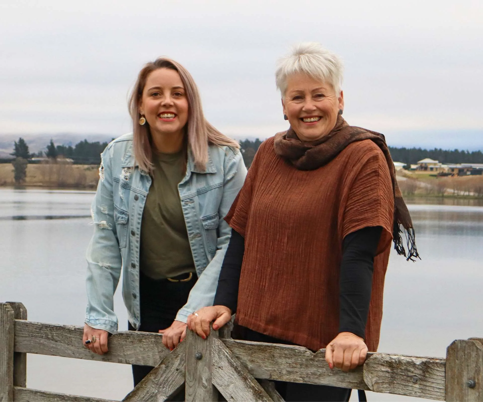 Leaning on a wooden fence on a wharf with mum Pam