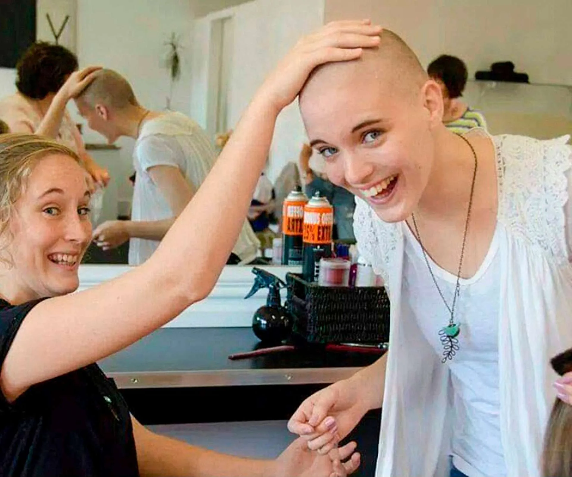 Sister Liv patting Georgia's freshly shaved head