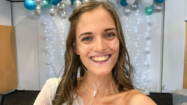 Georgia smiling with an oxygen tube in her nose
