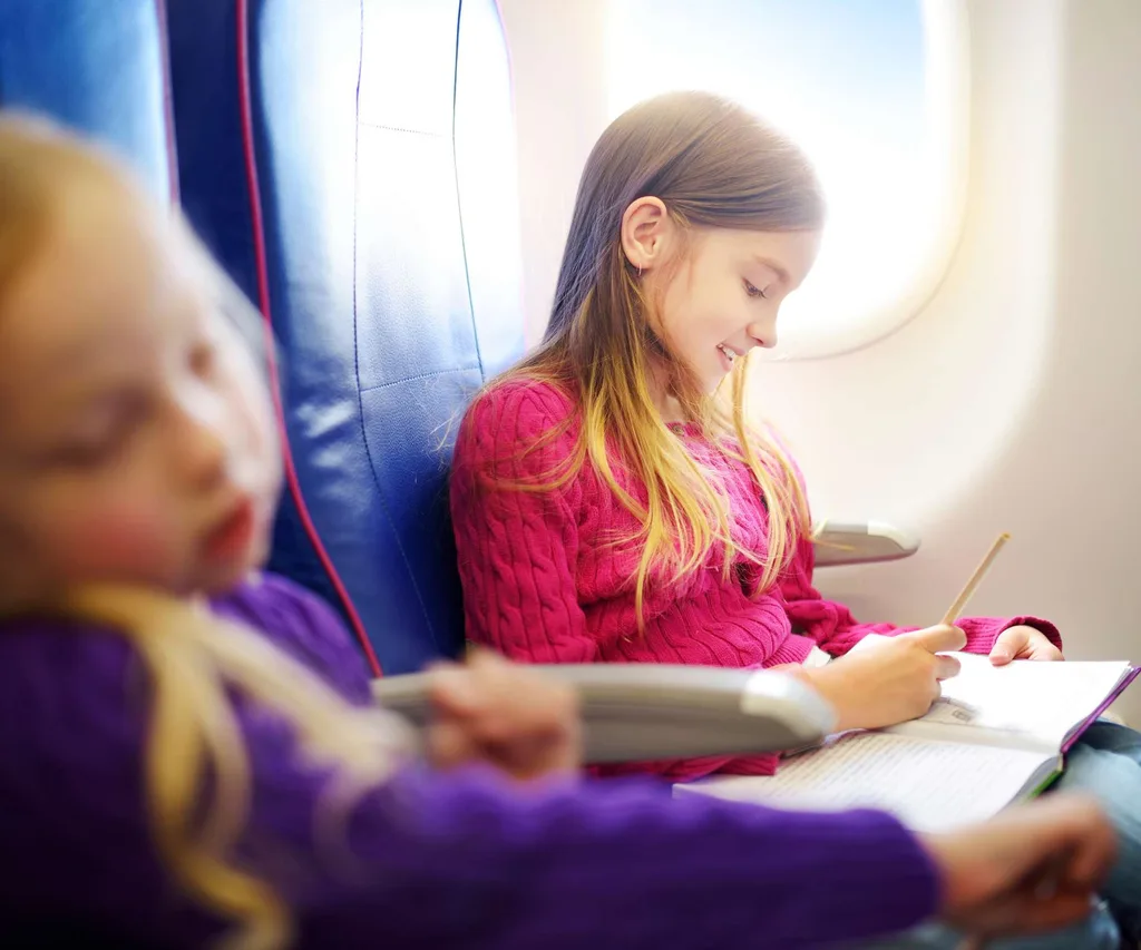Two kids flying economy