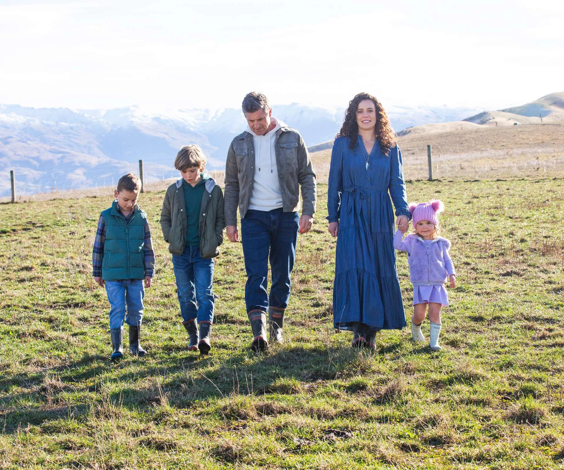 Matt walking on the farm with wife Ellen and their kids