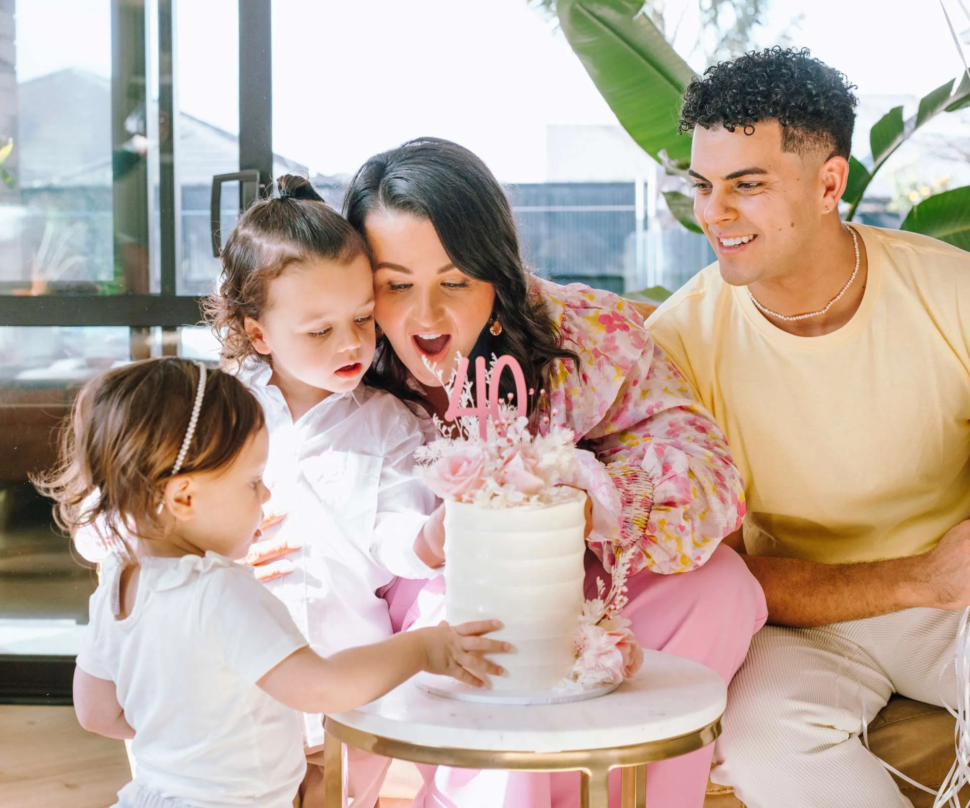Showing the kids the decorations on her 40th birthday cake