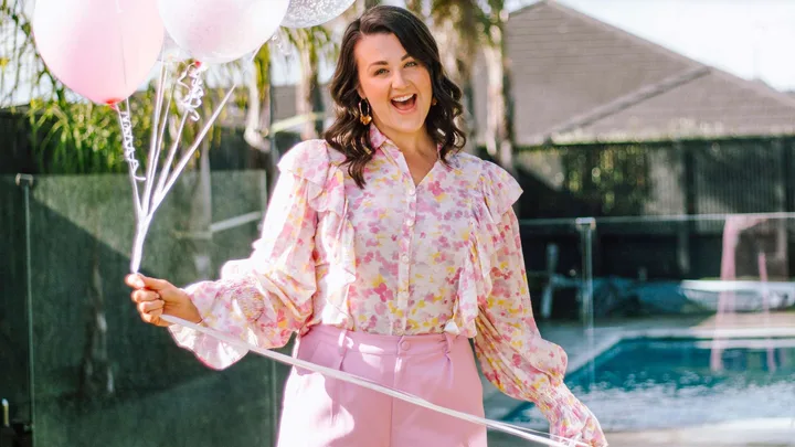 Megan Papas holding pink helium balloons for her 40th birthday