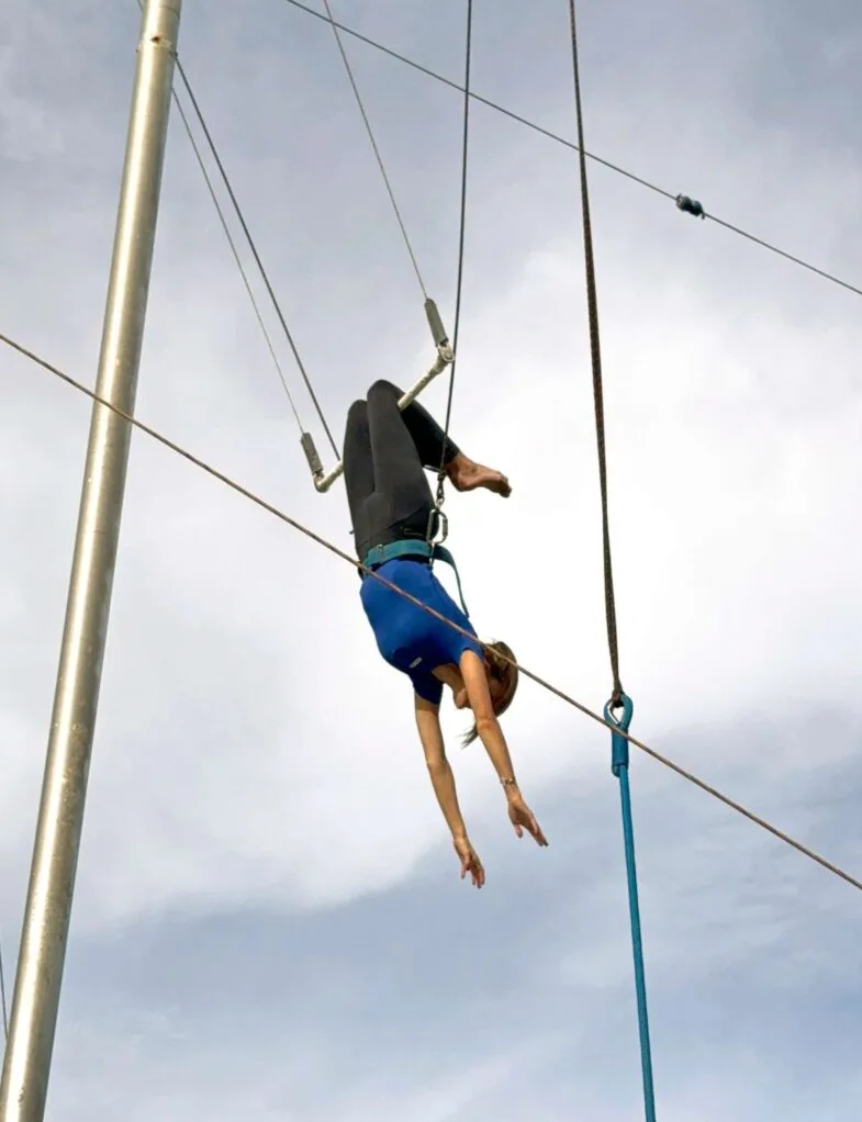 Anna Lee swinging from a trapeze at Club Med Phuket