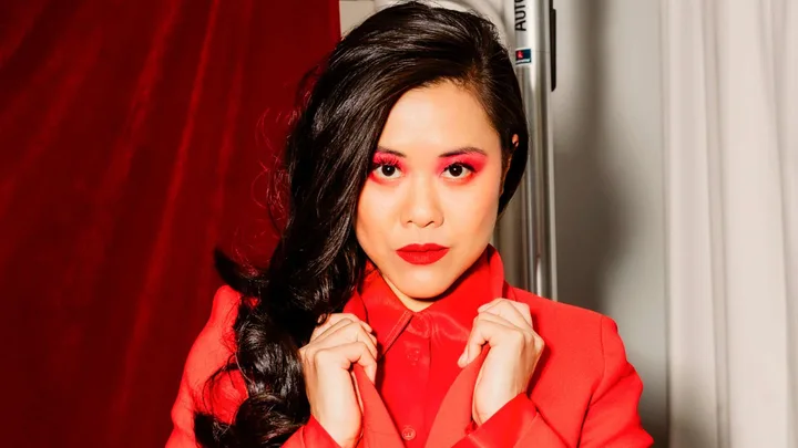 Dawn Cheong in a red coat with red eyeshadow