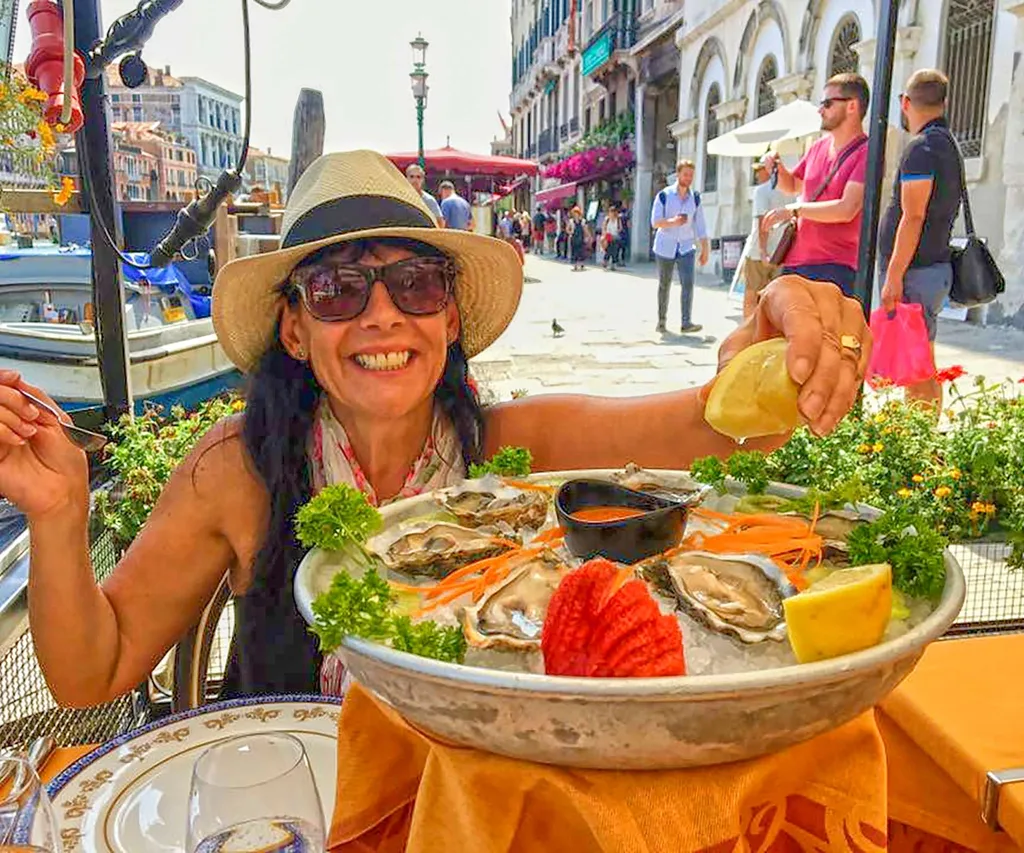 Michèle A’Court squeezing a lemon onto a bowl of oysters