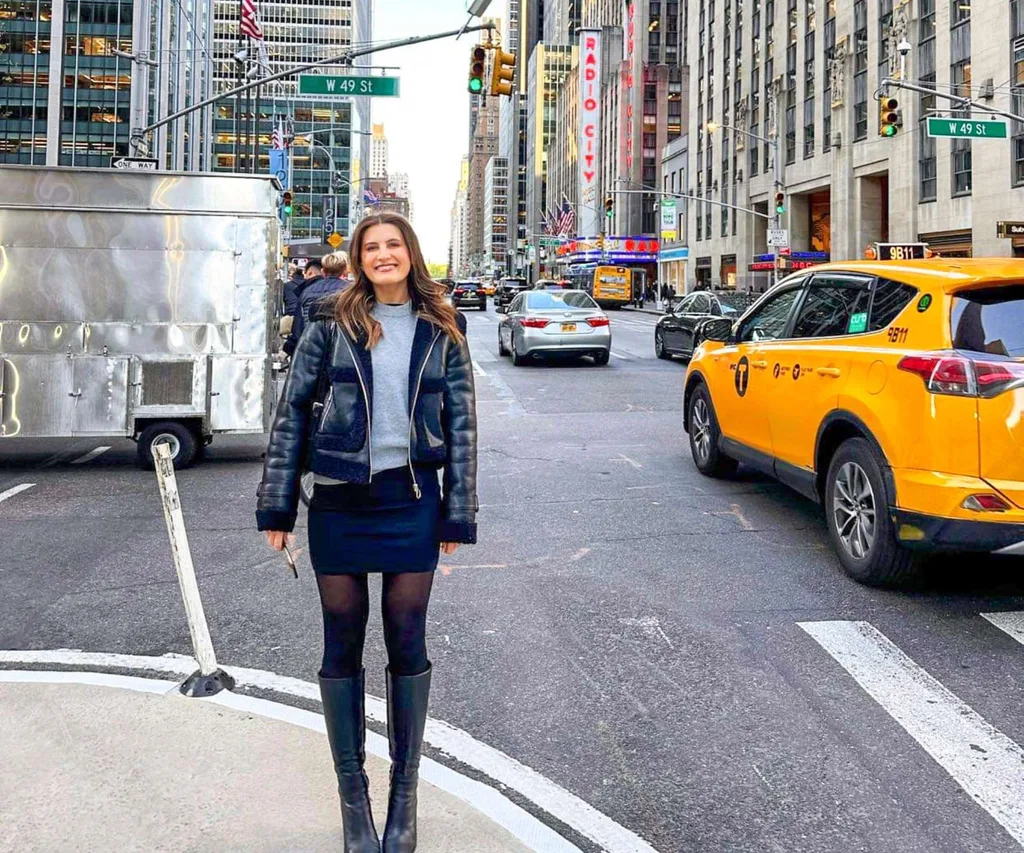 Madison Reidy on the corner of two busy New York streets