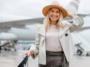 A woman smiling after her flight from using her in-flight beauty essentials