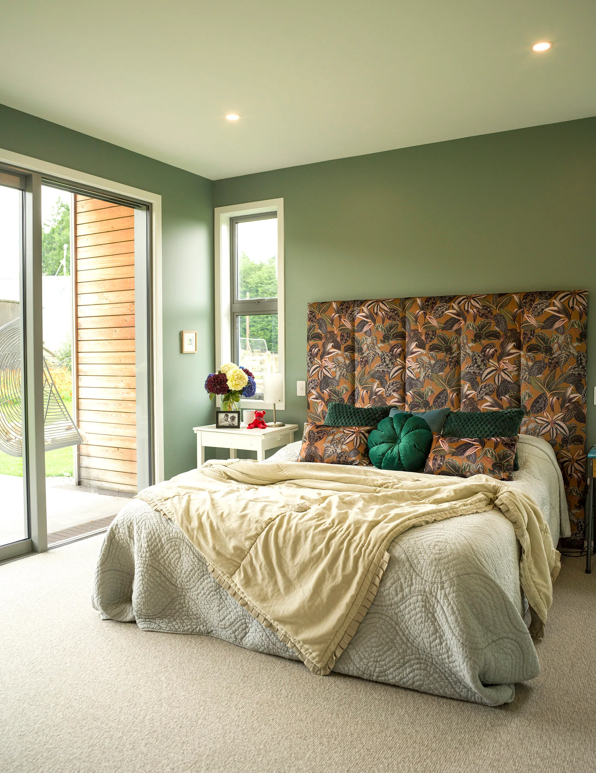 The main bedroom is a restful retreat painted
in Resene Smoky Green