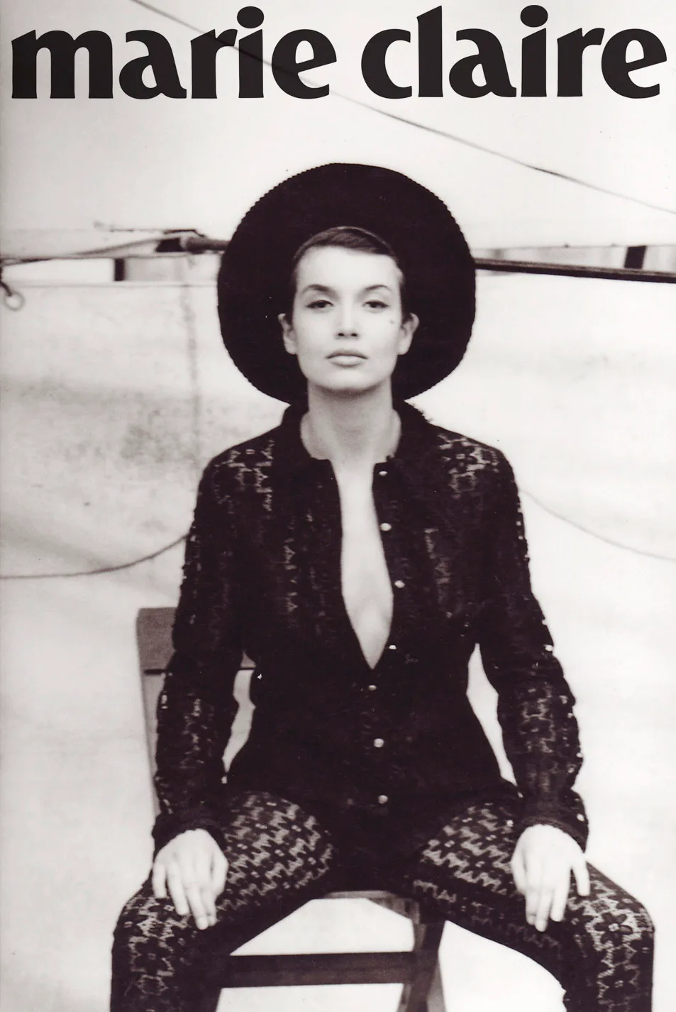 black and white magazine cover of model in black lace jumpsuit