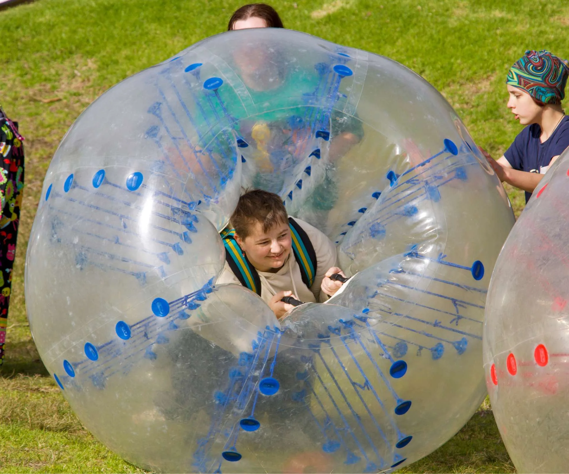 Finn Everall in a giant zorb ball at Camp Quality