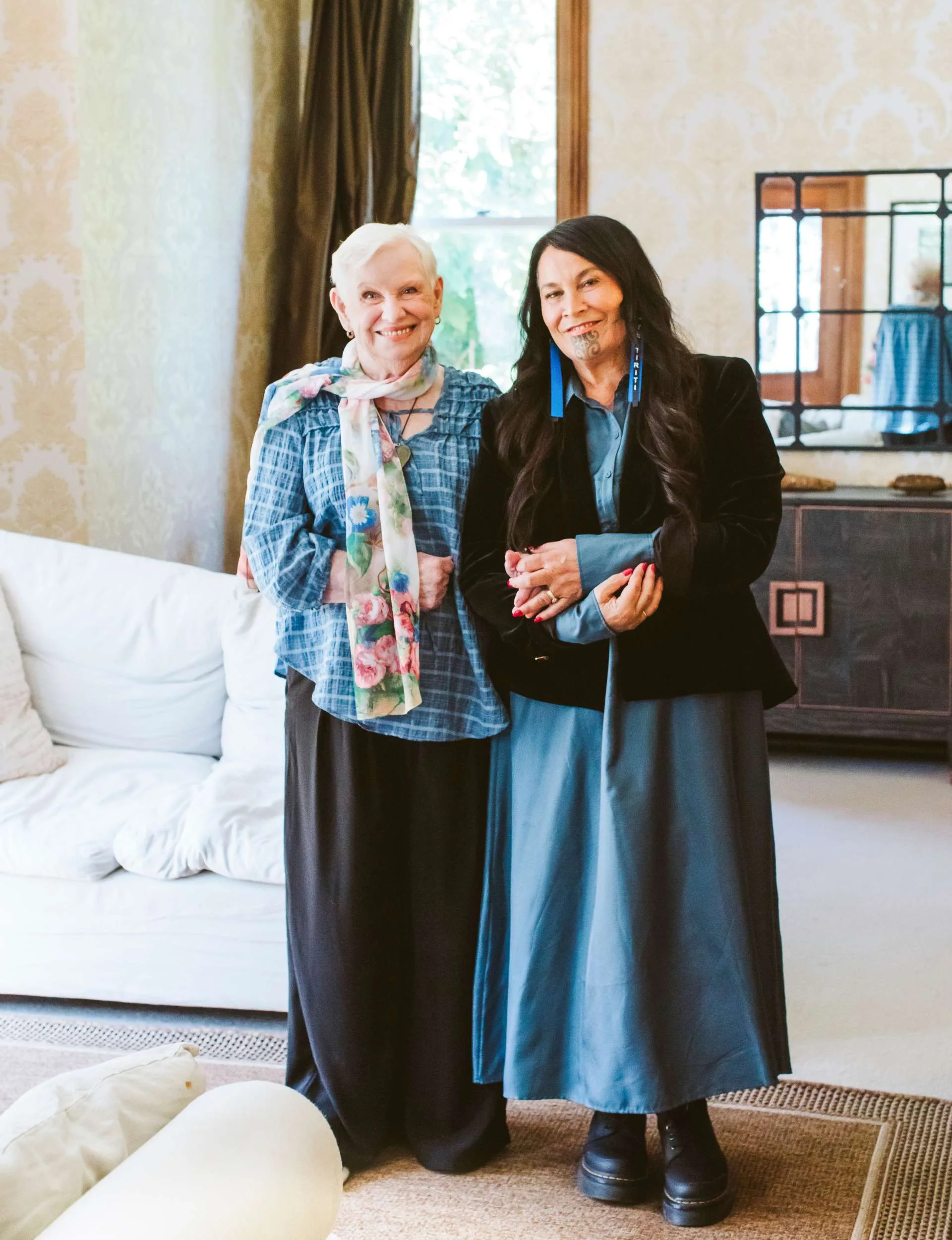 The mother-daughter duo standing with their arms interlinked