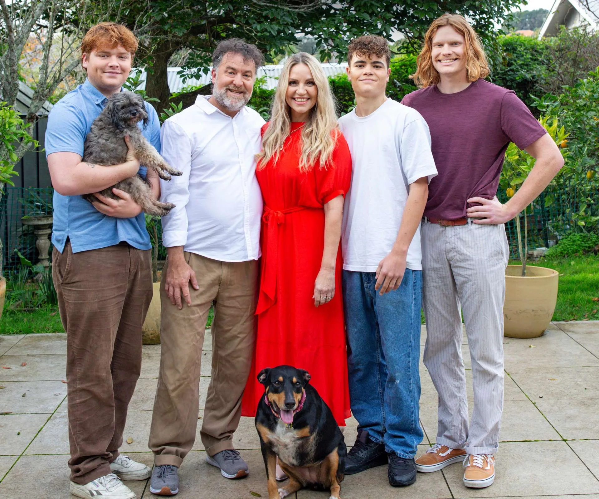 Mel Homer surrounded by her sons, husband and their two dogs