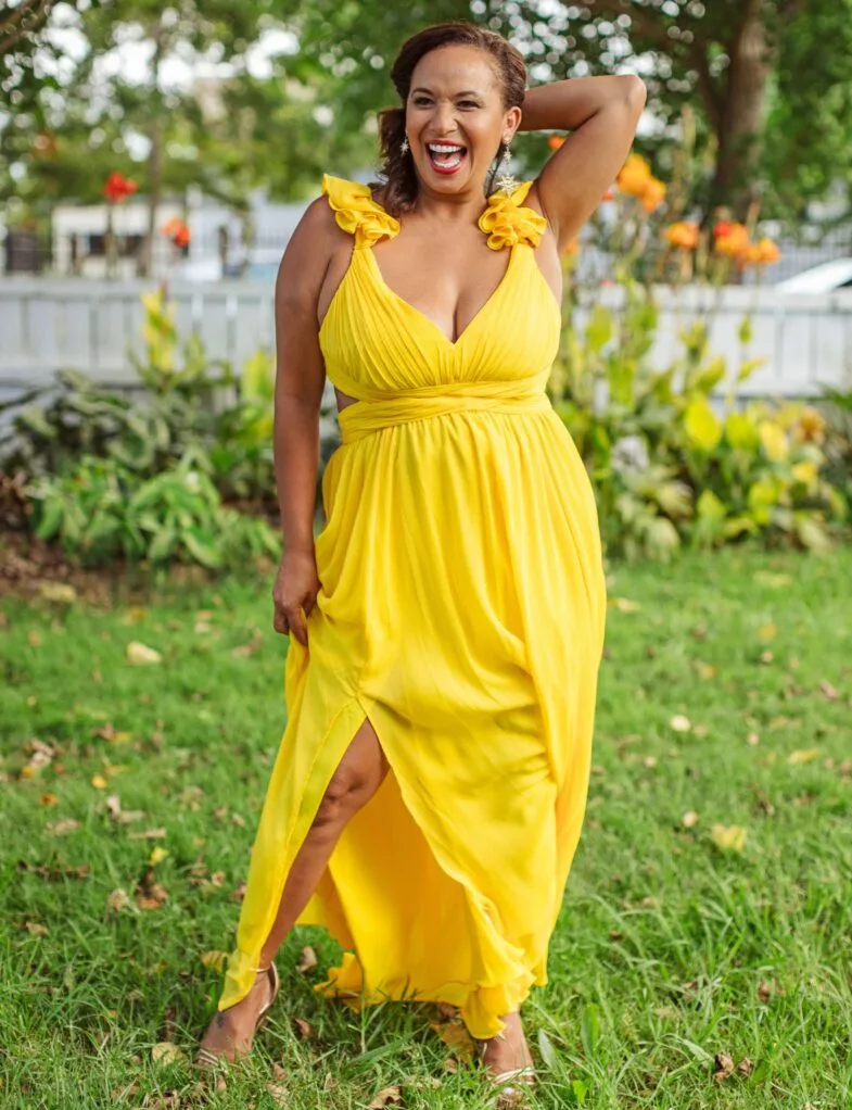 Megan smiling in a yellow dress