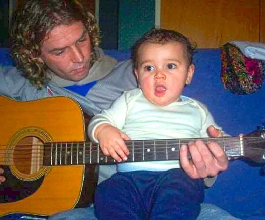 Otis' dad playing the guitar around him when he was a baby