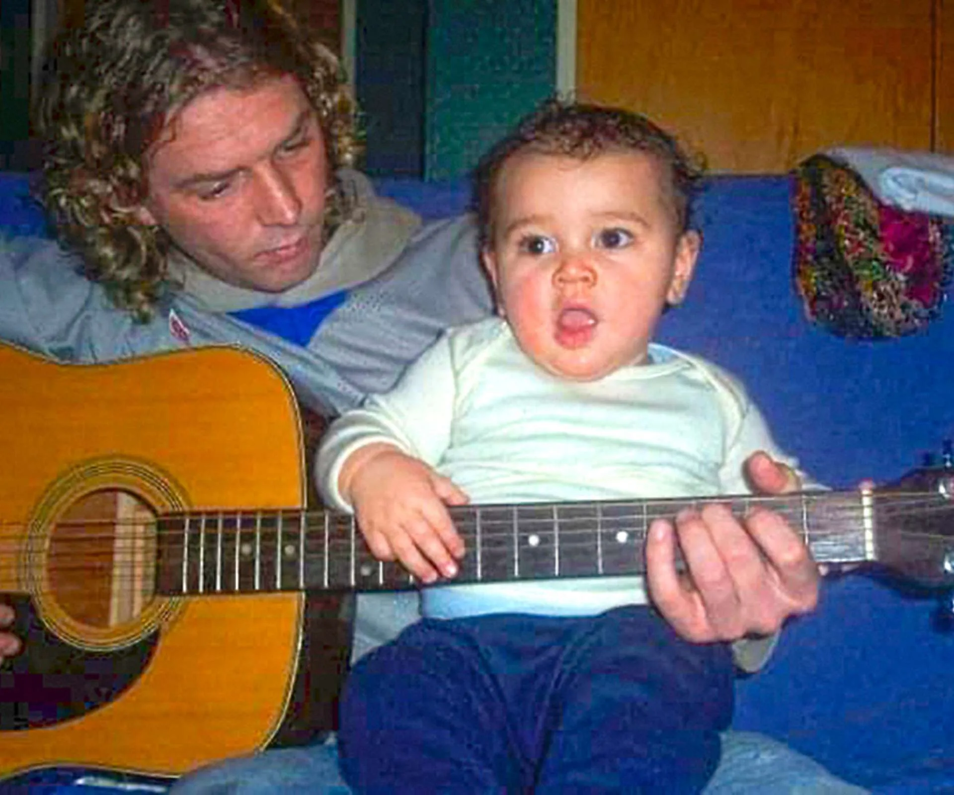 Otis' dad playing the guitar around him when he was a baby