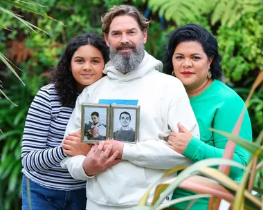 Otis Hill's parents and sister holding a photo of him