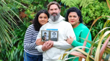 Otis Hill's parents and sister holding a photo of him