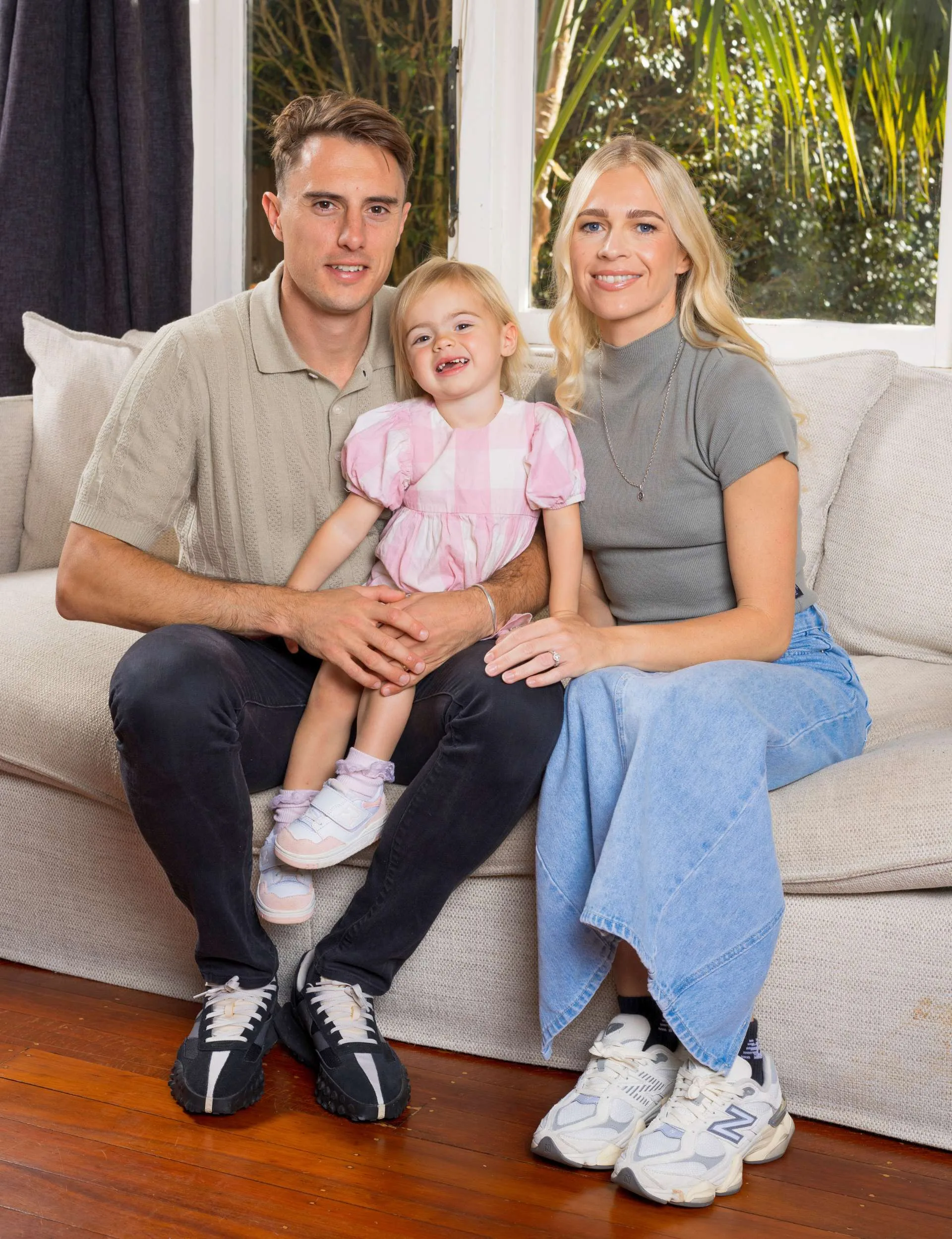 Camille with Cameron, who is holding daughter Sienna on his lap on the couch