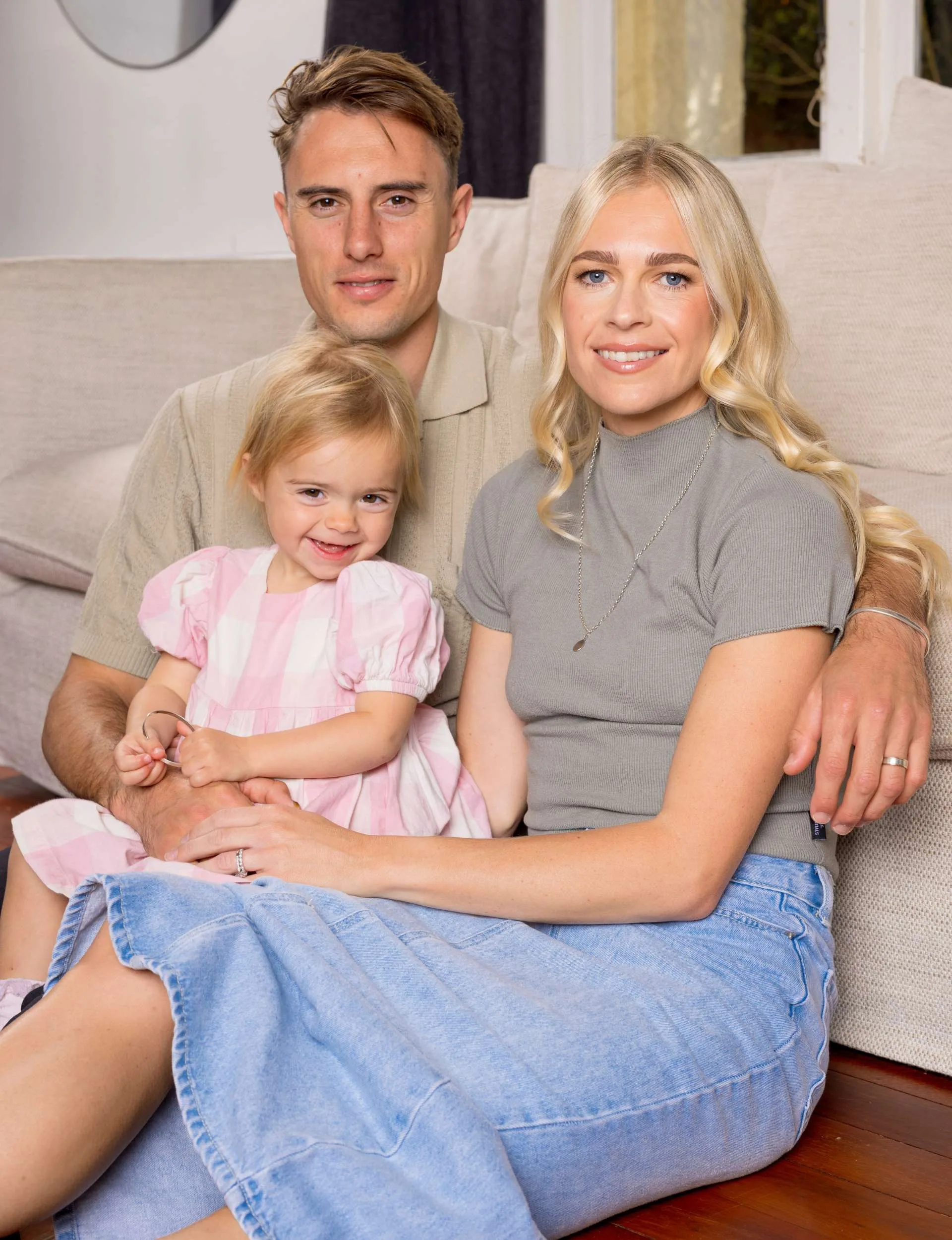 Camille with Cameron, who is holding daughter Sienna on his lap on the couch