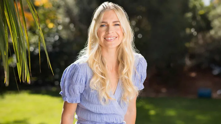 Camille French in a purple dress smiling