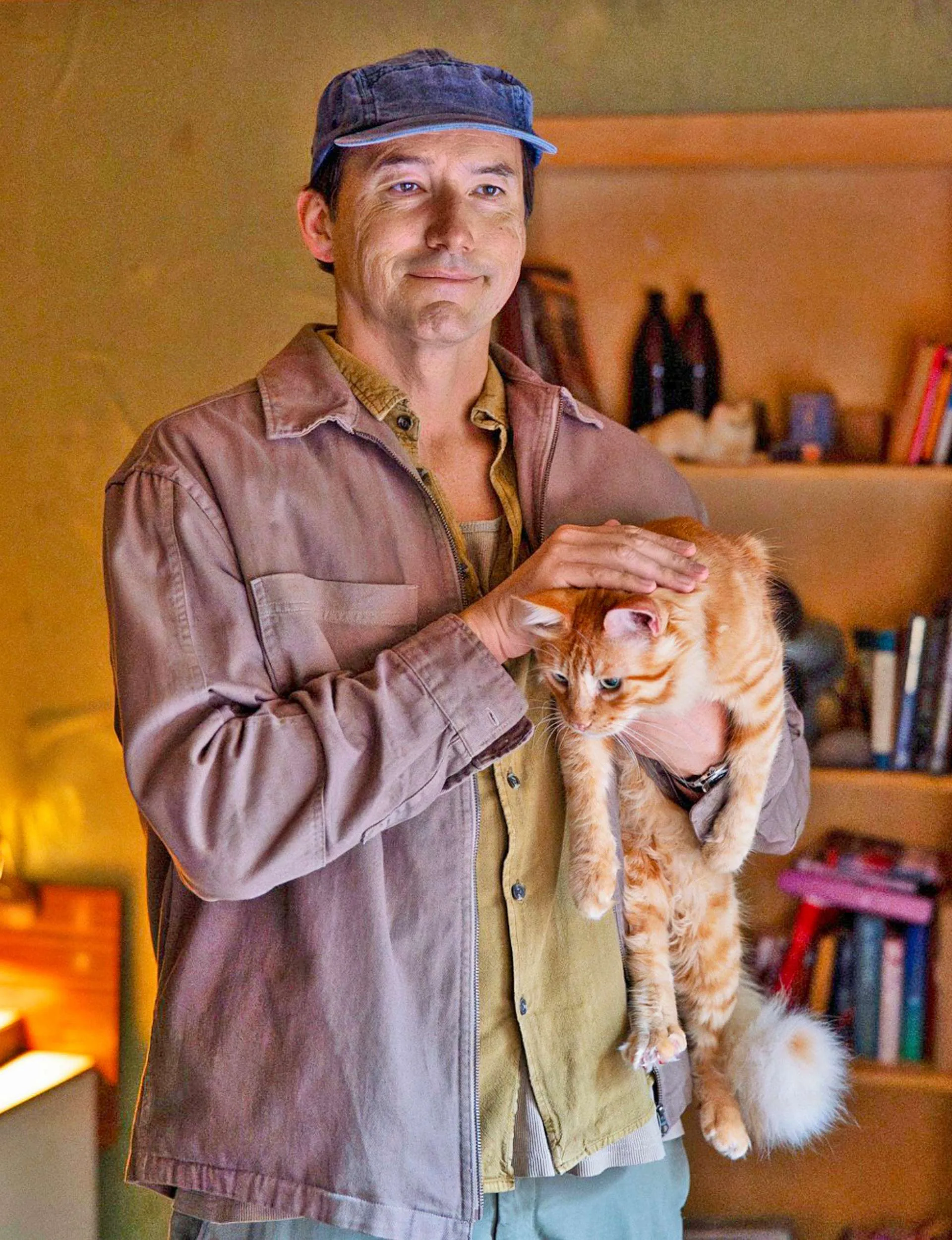Dark City: The Cleaner star Cohen Holloway holding a ginger cat