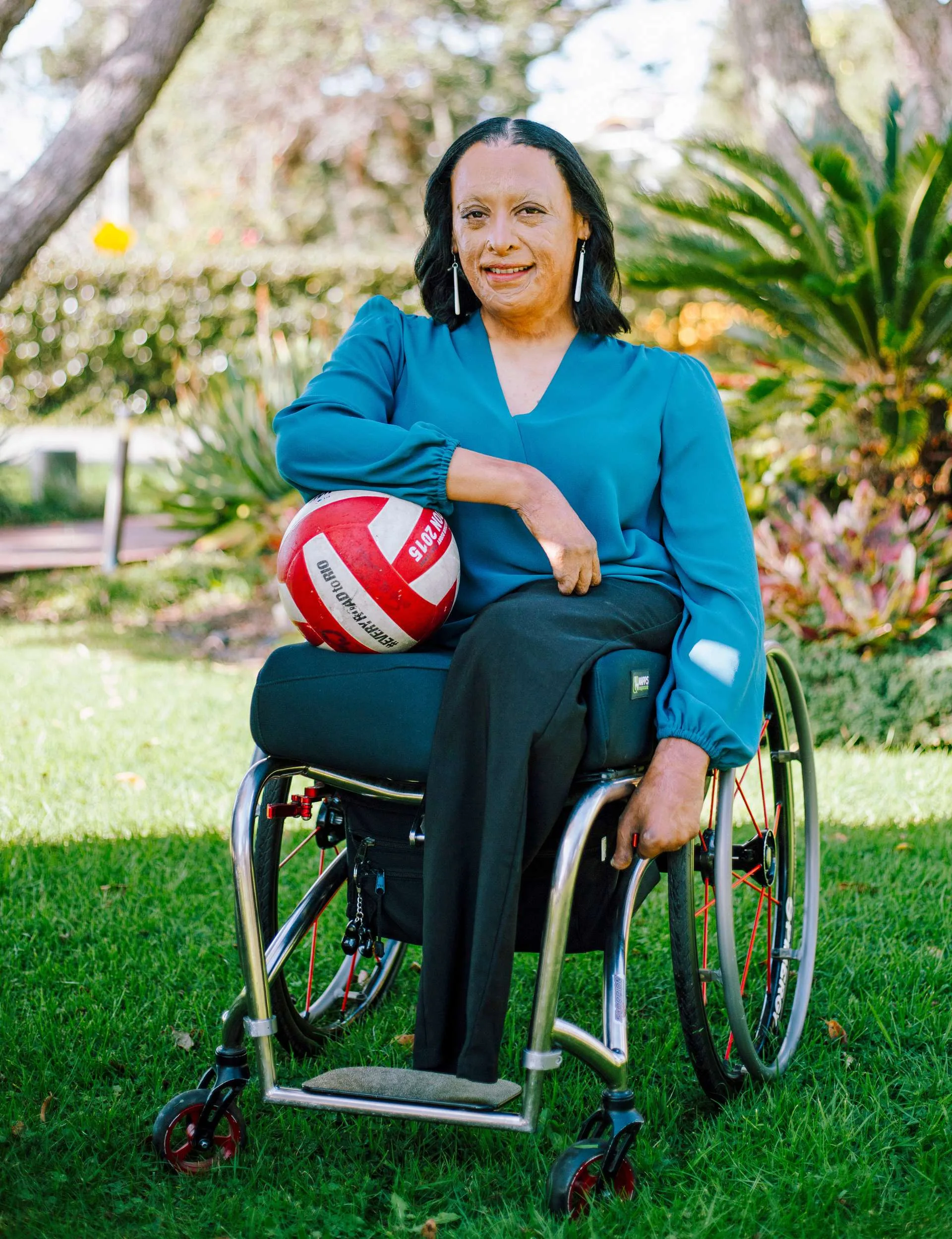 Maia Marshall-Amai in her wheelchair with a ball