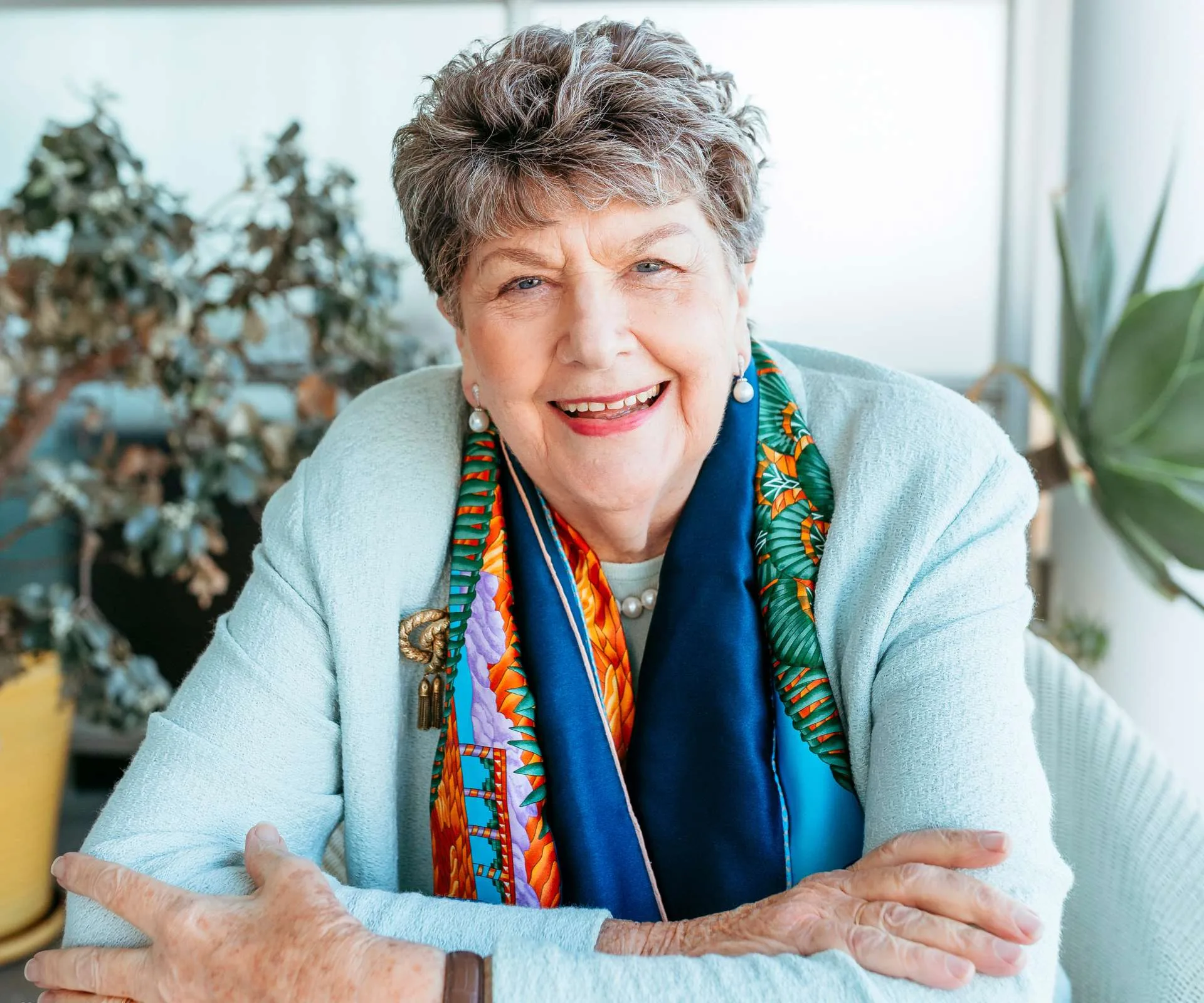 Dame Wendy Pye smiling in a light blue cardigan
