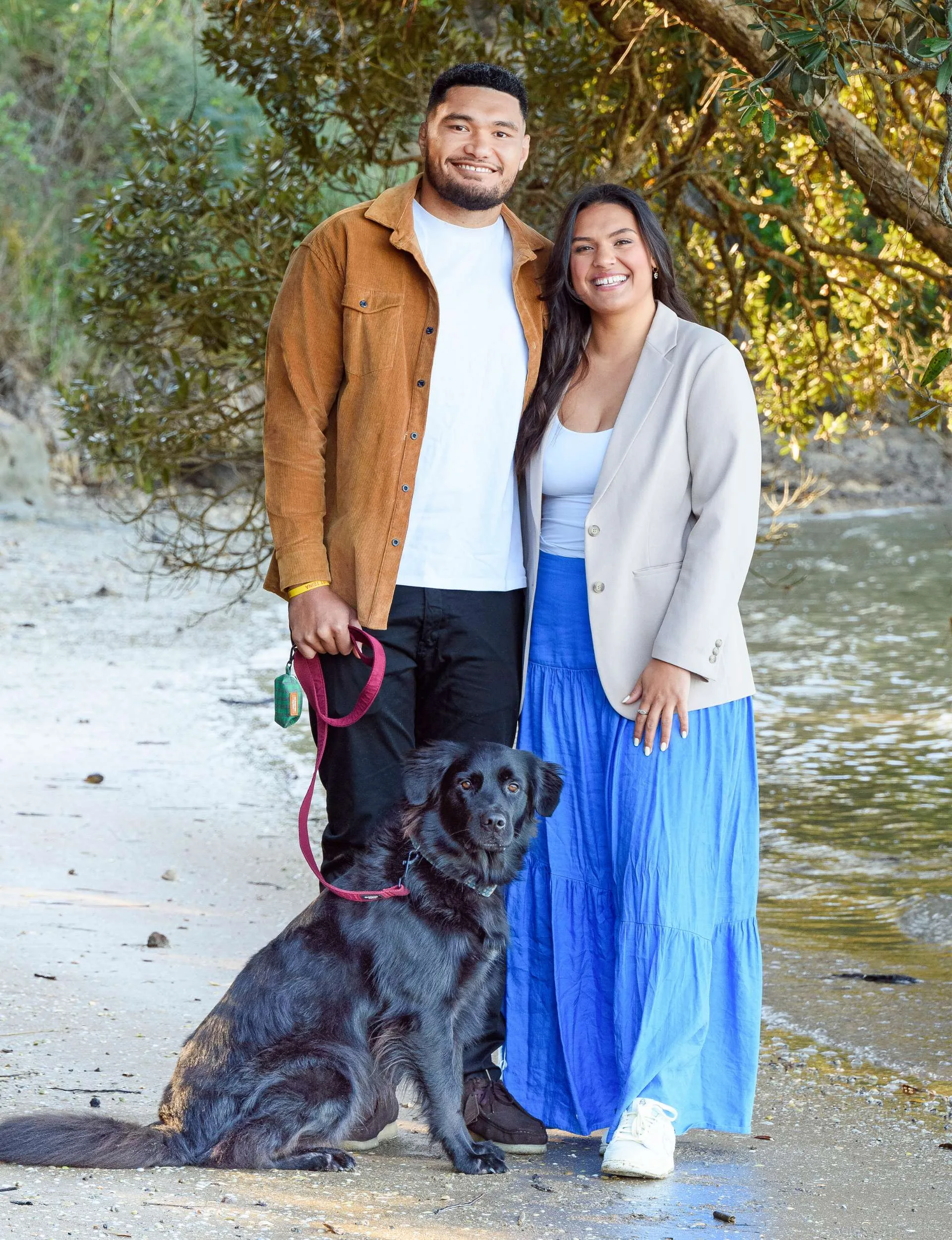 Britt, Cameron and dog Arlo on a beach