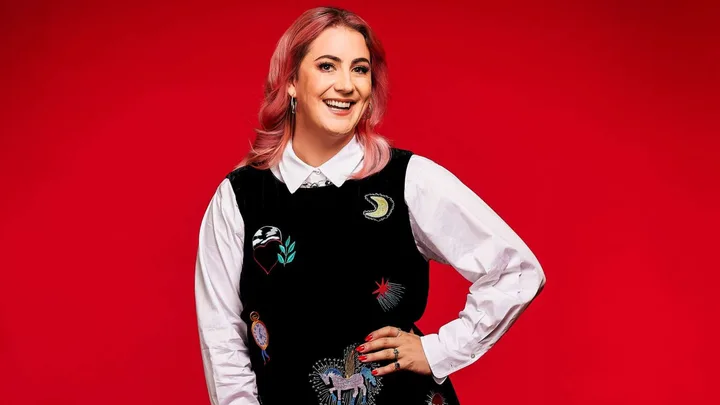 Hayley Sproull in front of a red background