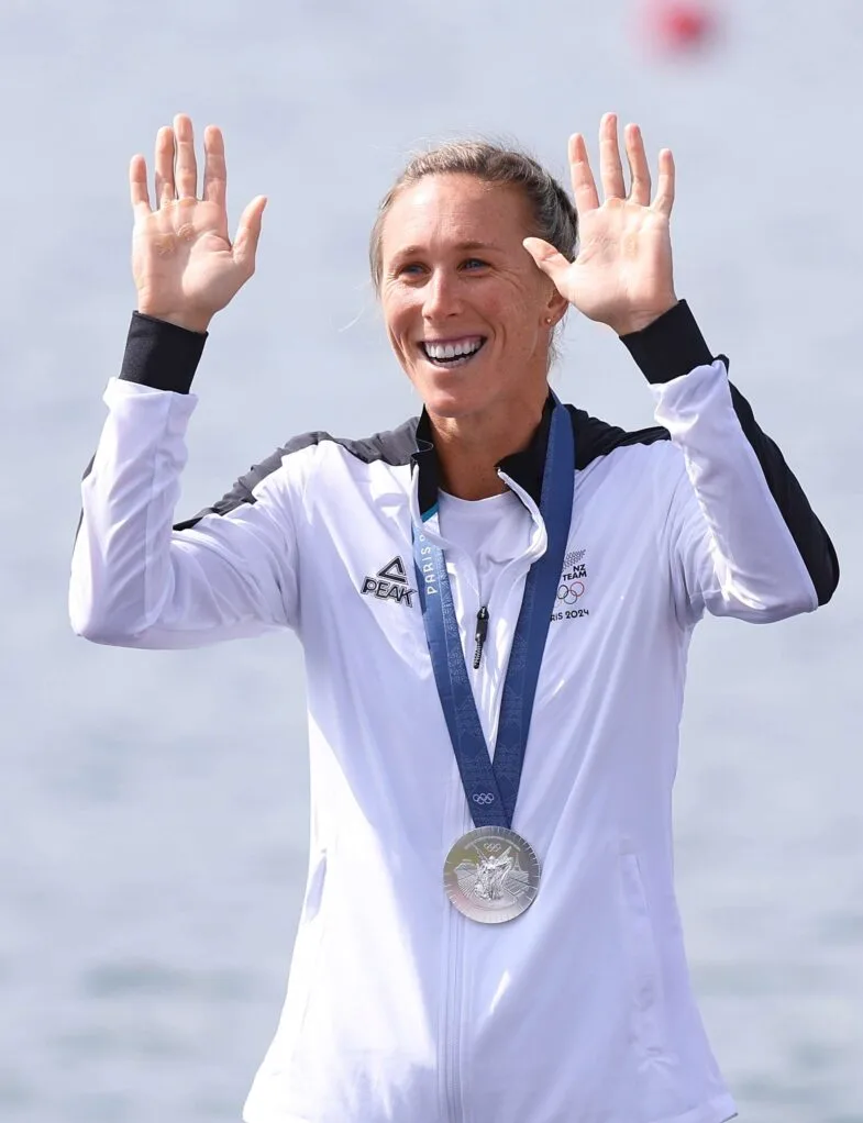 Emma Twigg waving to the crowd from the Olympic podium