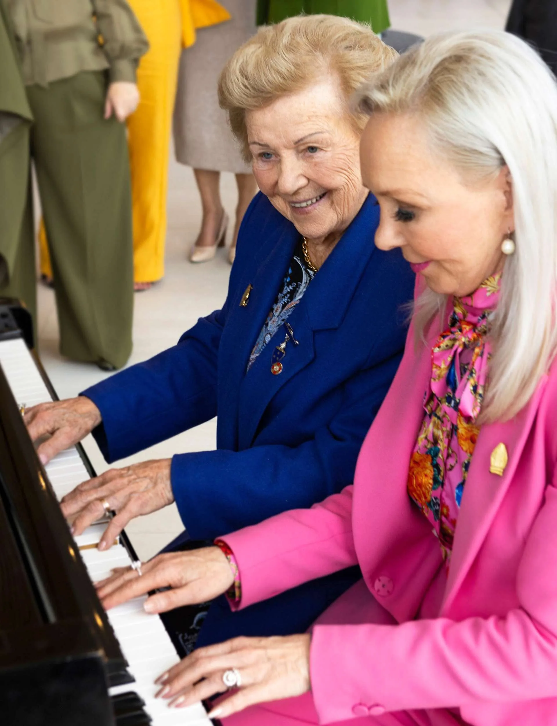 Desley playing the piano beside her mum