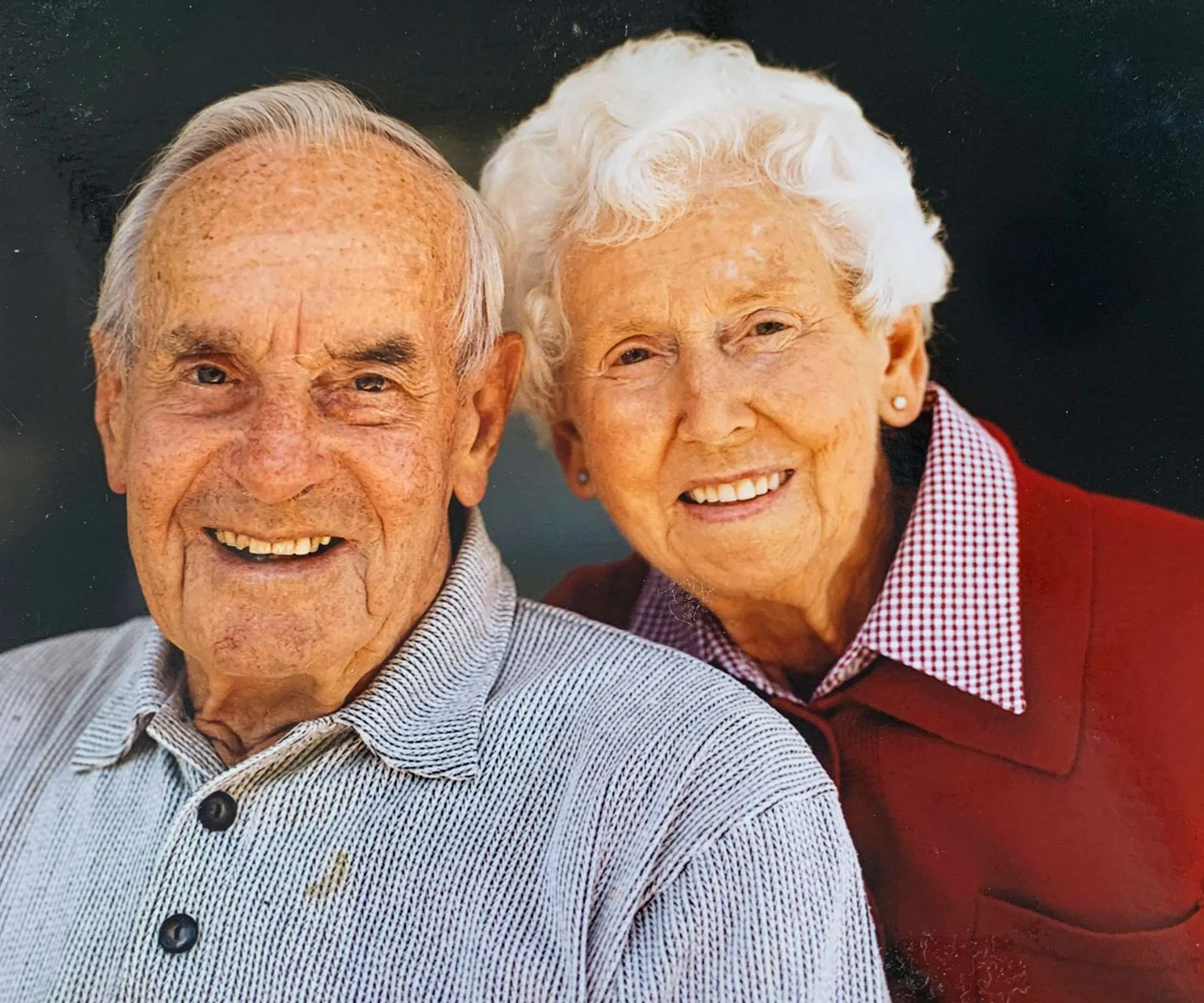 Sam's grandparents smiling in an older photograph