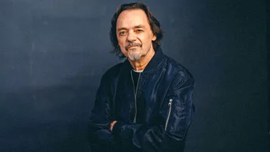 Jimmy Brown in front of a dark background