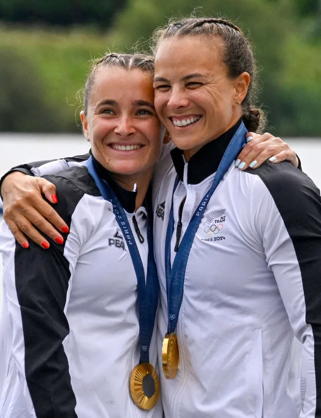 Dame Lisa and Alicia proudly hugging on the podium