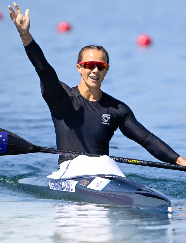 Lisa Carrington waving from in her kayak at the 2024 Paris Olympics