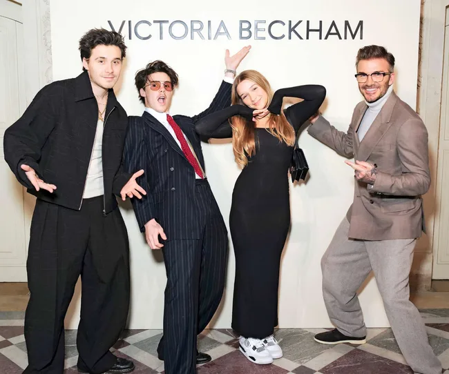 One of the celeb dads is David Beckham with his kids under a sign with Victoria's name on it
