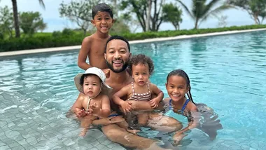 Celeb dad John Legend in a pool with his kids