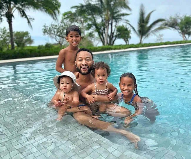 Celeb dad John Legend in a pool with his kids