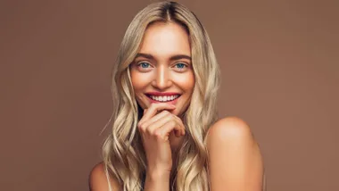 A model smiling after using the best lip balms