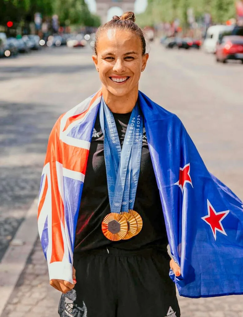 Lisa with the New Zealand flag before the 2024 Olympics closing ceremony