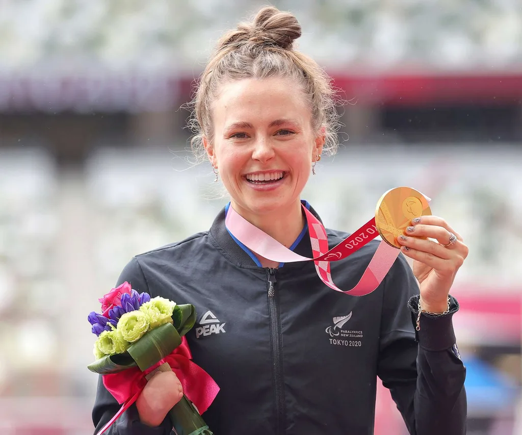 Anna holding up her gold medal