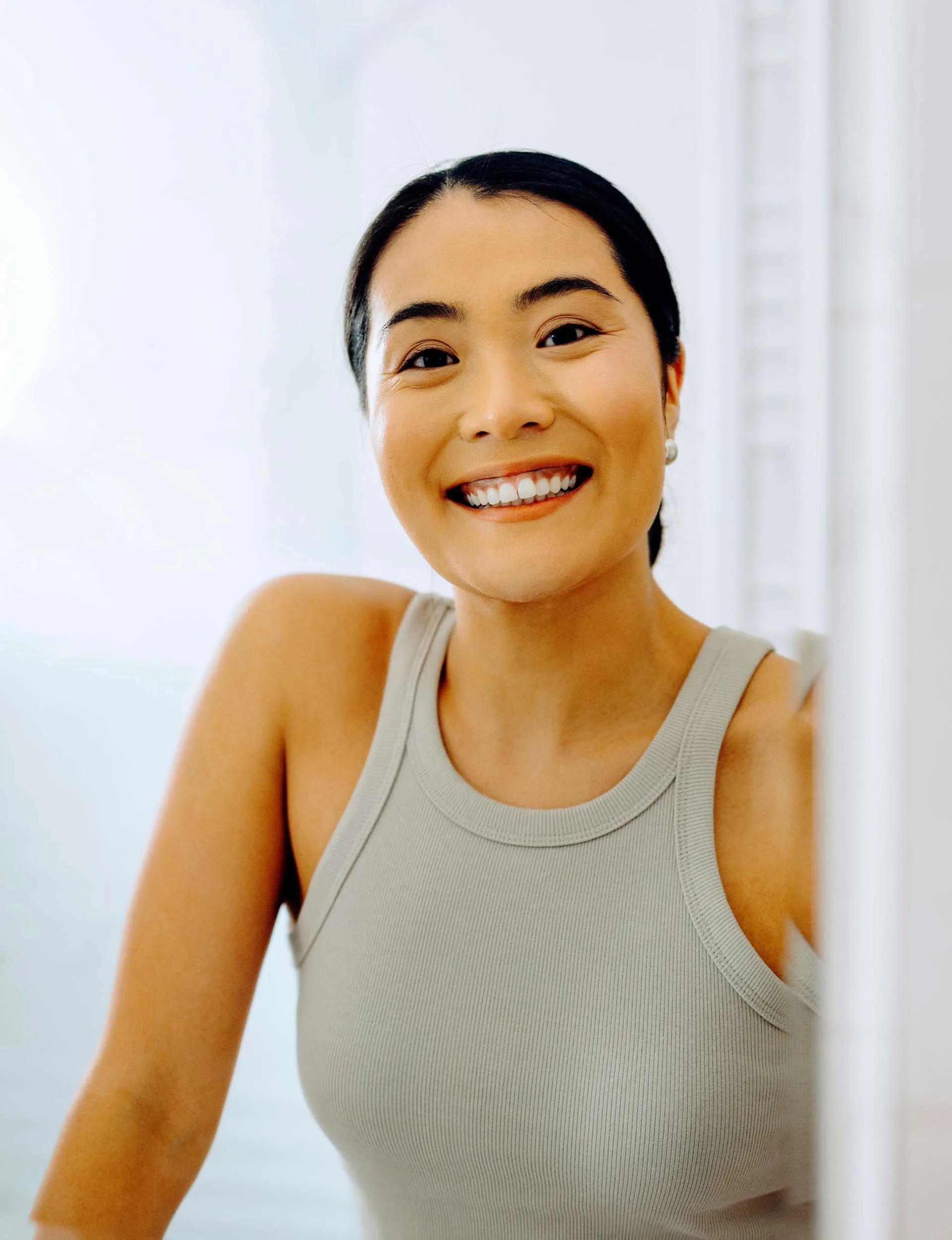 A woman with great dental care looking in the mirror