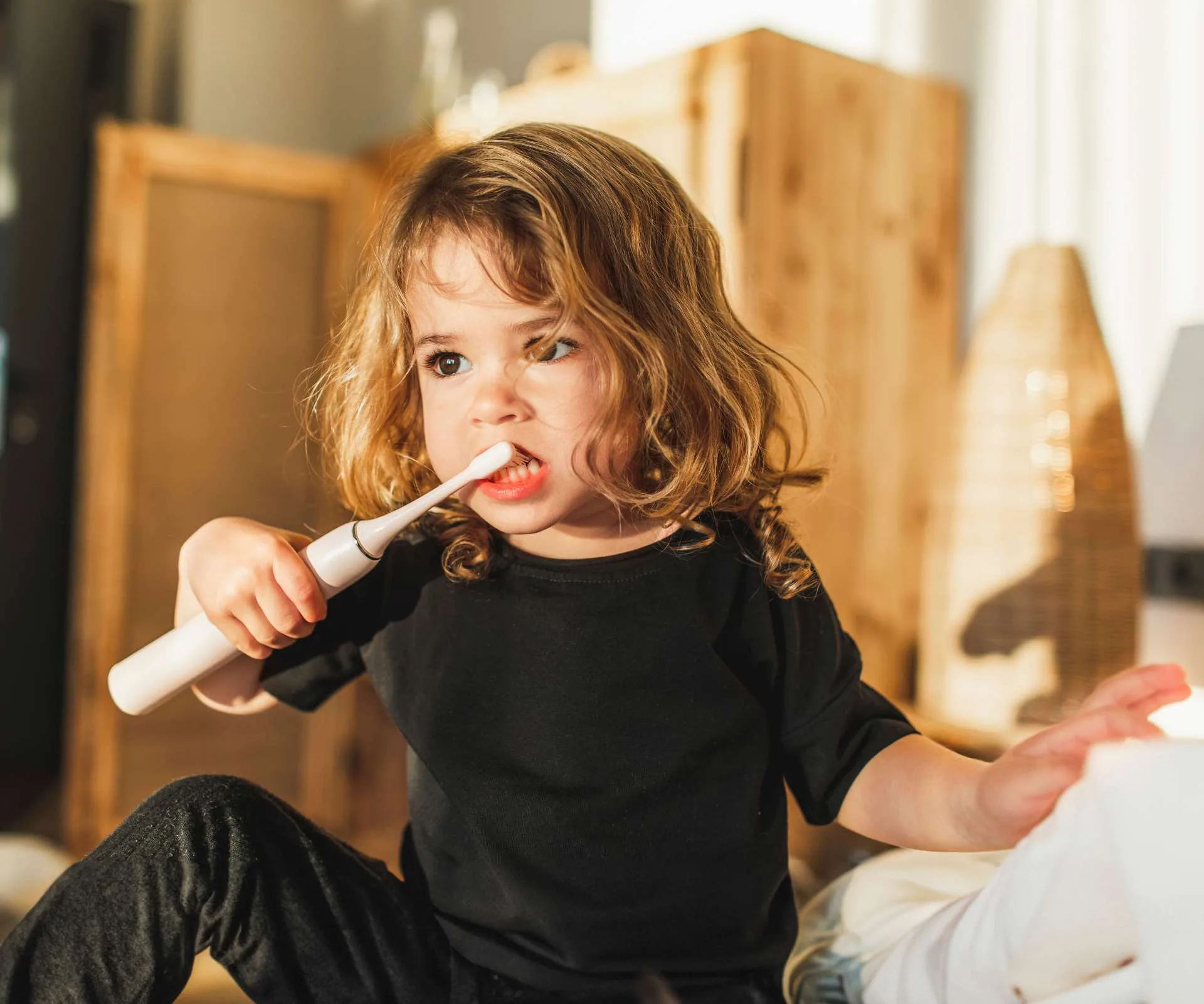 A kid brushing their teeth for great dental care