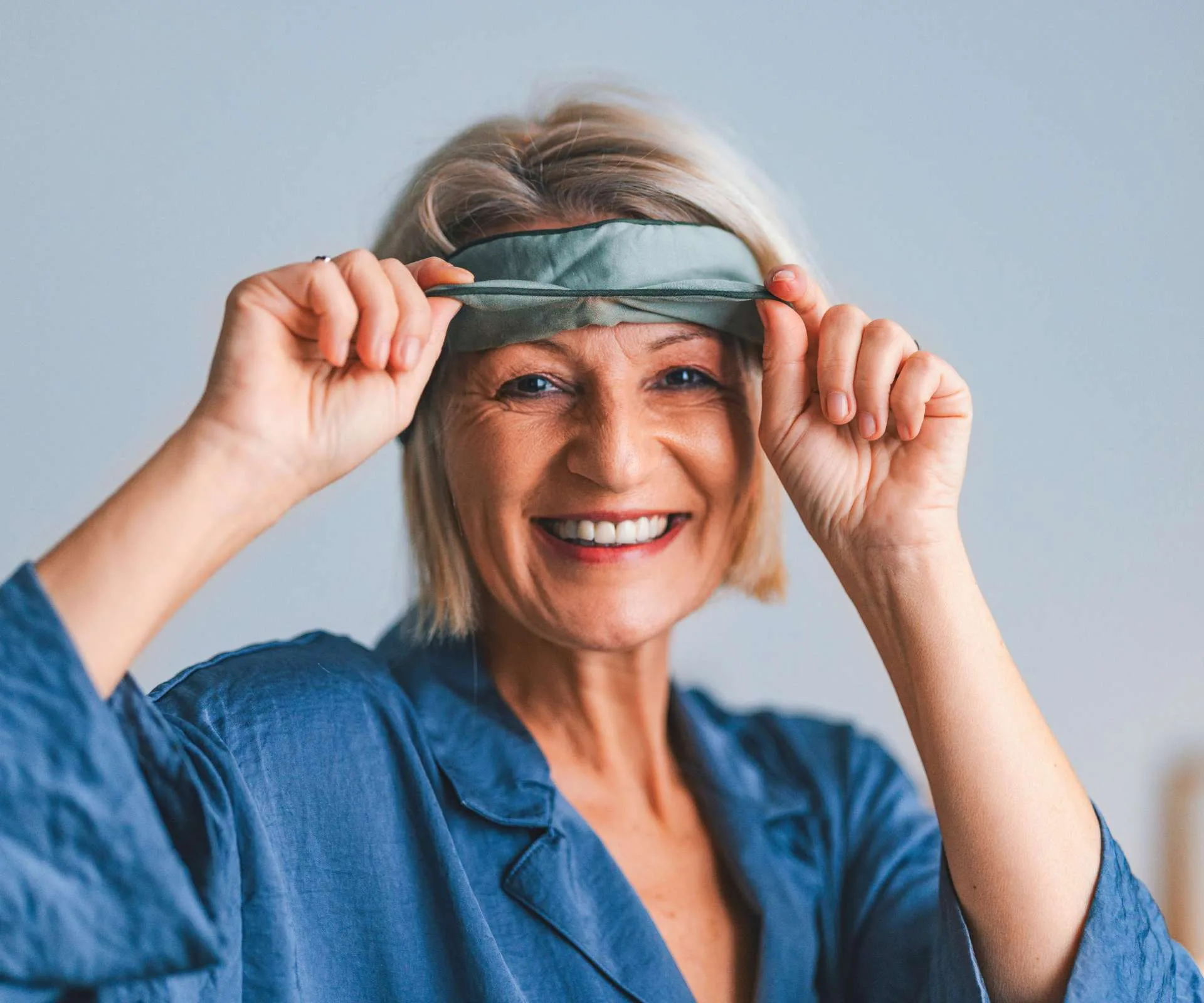 A woman with great dental care Holding a sleeping mask