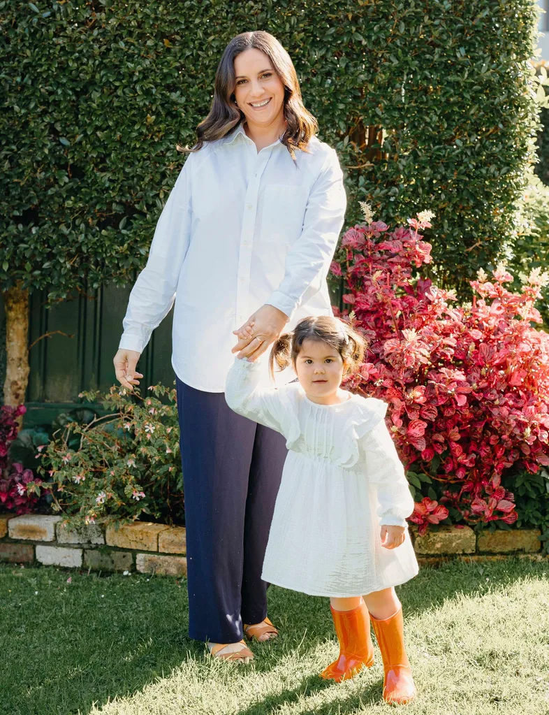 Laura Tupou with her youngest daughter, Ava on the lawn