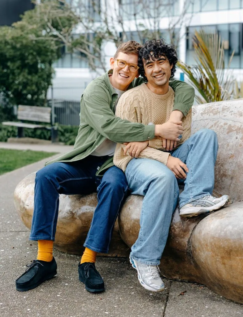 Chris and Micheal hugging on a rock seat