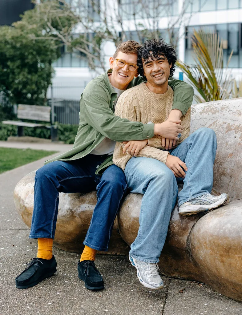 Chris and Micheal hugging on a rock seat