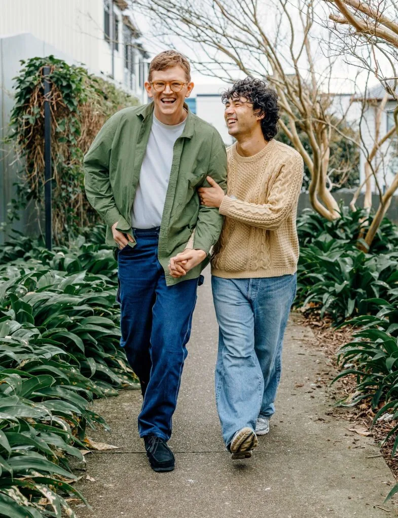 Chris and Micheal walking down a path with linked arms